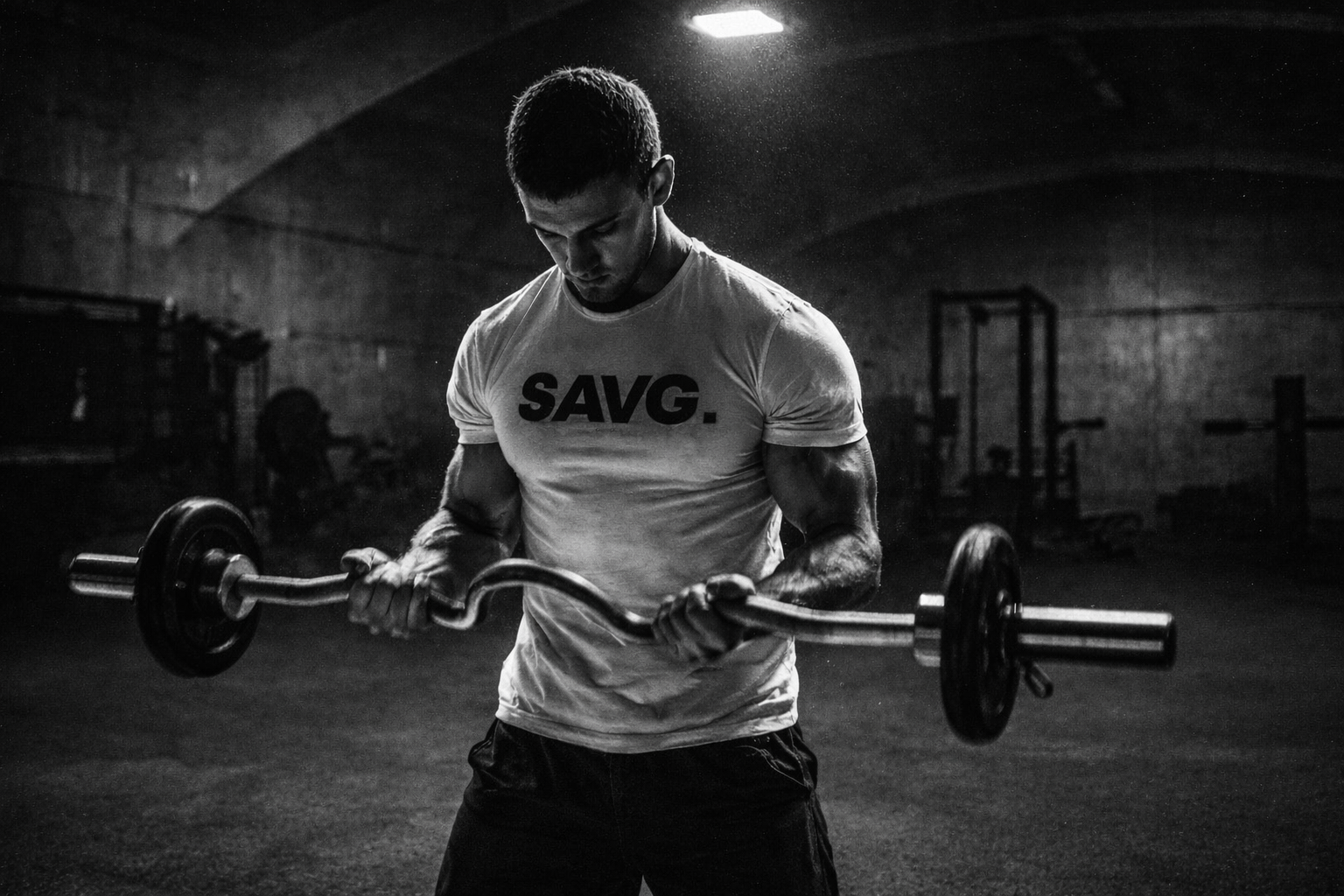 Built different guy who is lifting and posing. He is strong and dedicated. Wearing a muscular Fit T-shirt
