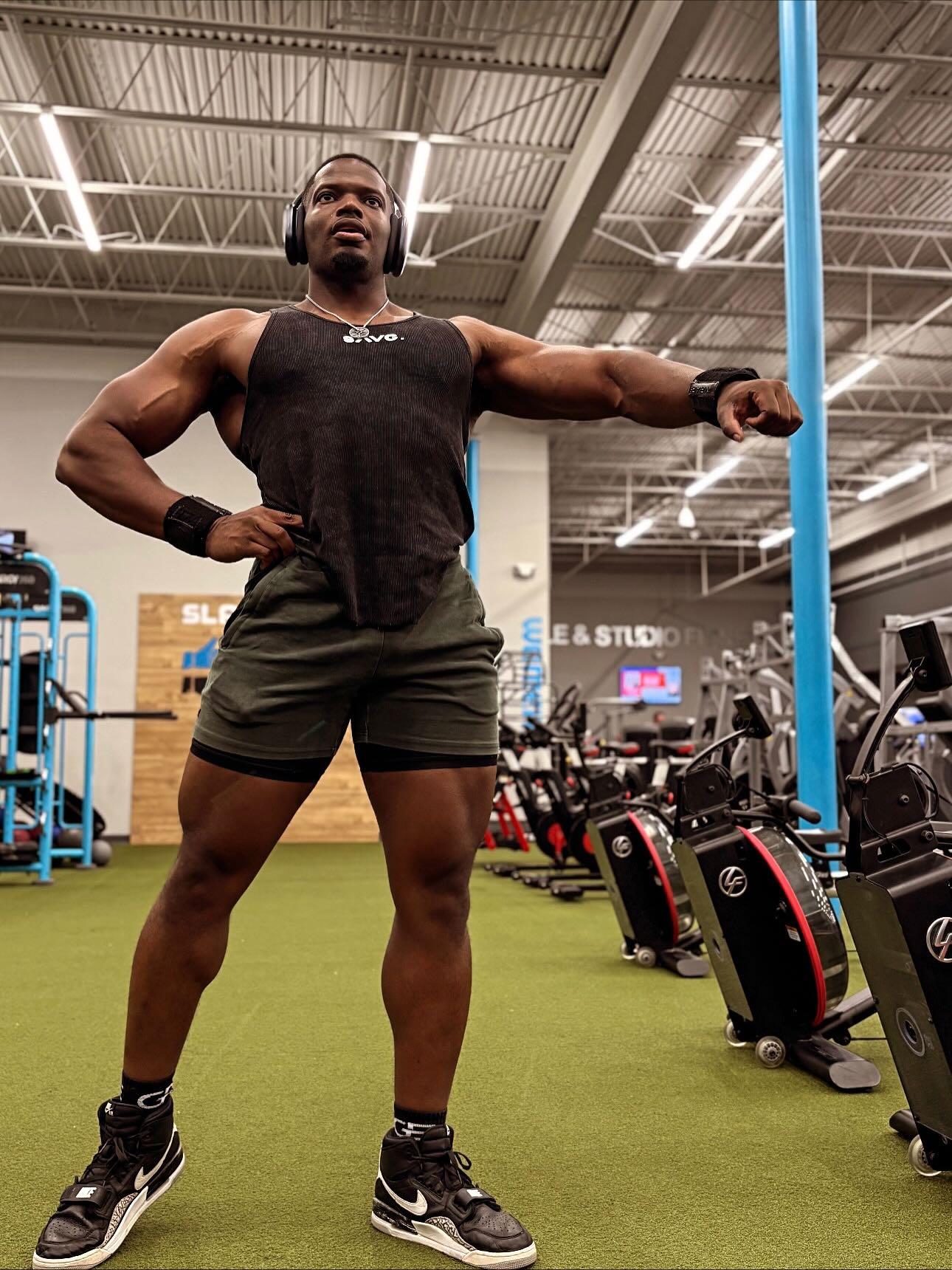 Built different guy who is lifting and posing. He is strong and dedicated. Wearing a muscular Fit T-shirt