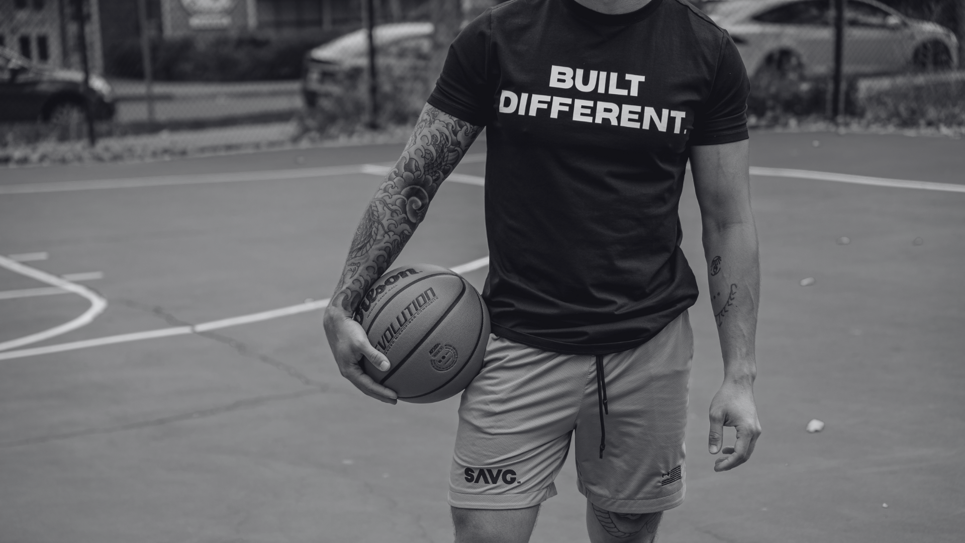 Built different guy who is lifting and posing. He is strong and dedicated. Wearing a muscular Fit T-shirt